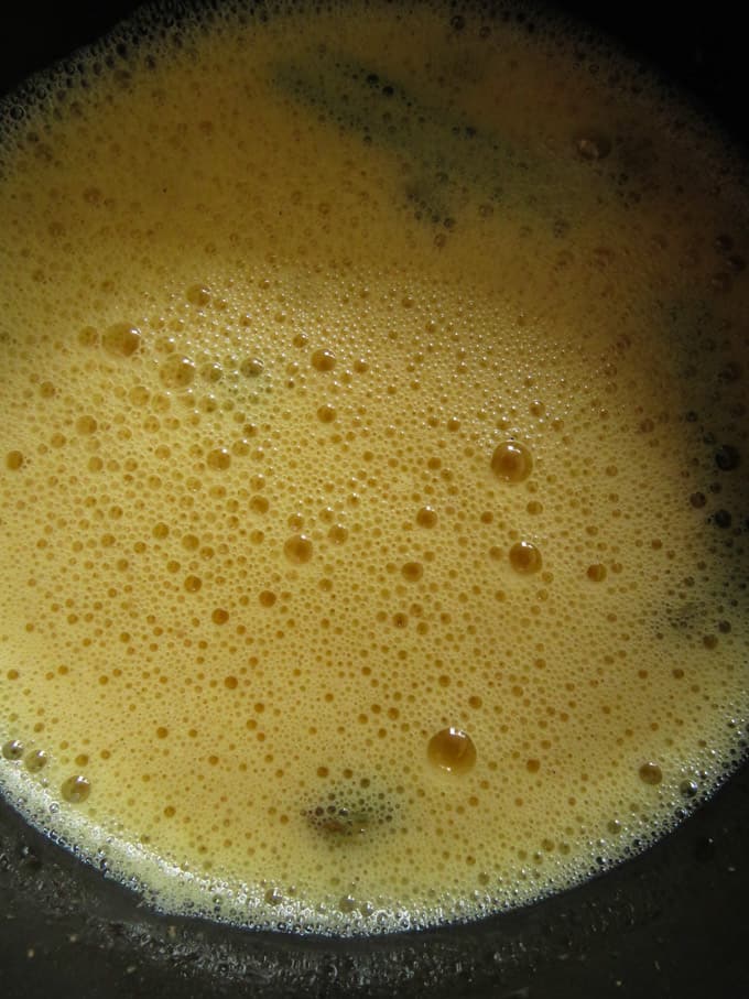 whisking the egg mixture for the watalappam.