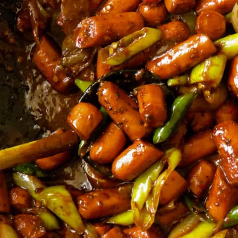 sausage(spicy devilled)stir fry with onions and peppers.