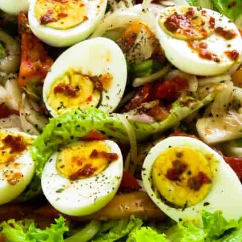 Boiled egg salad(spicy) with onions and tomatoes.