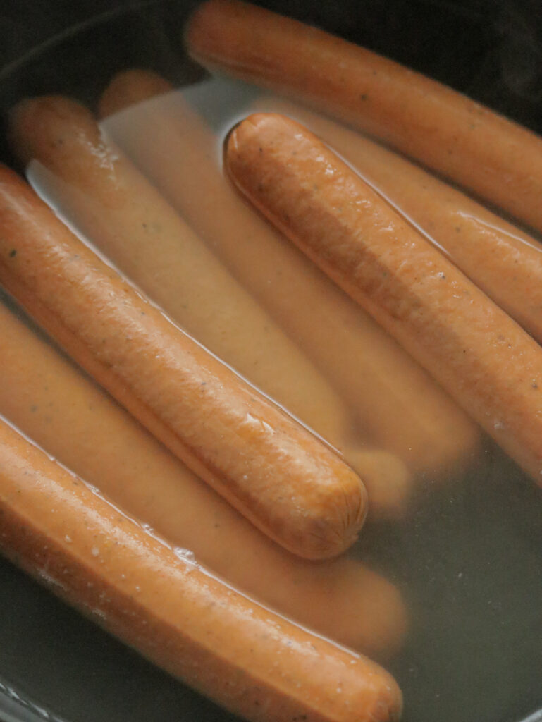 boiling the sausages to make the devilled sausage recipe