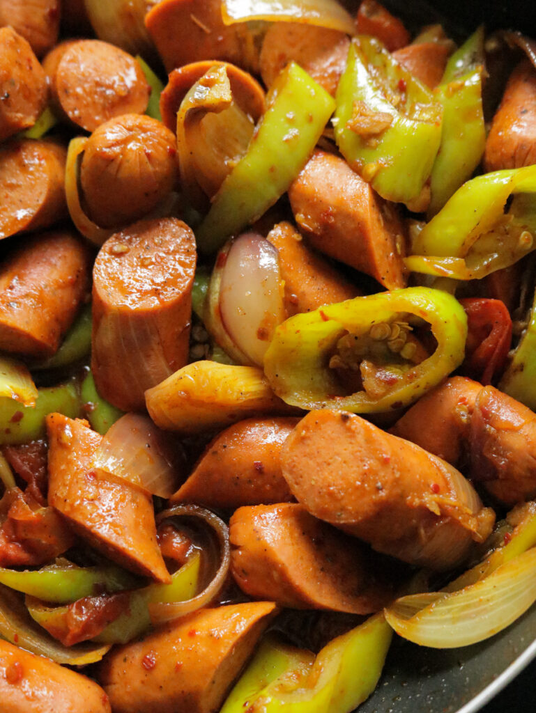 cooked sausages with green peppers and onions to make the devilled sausages