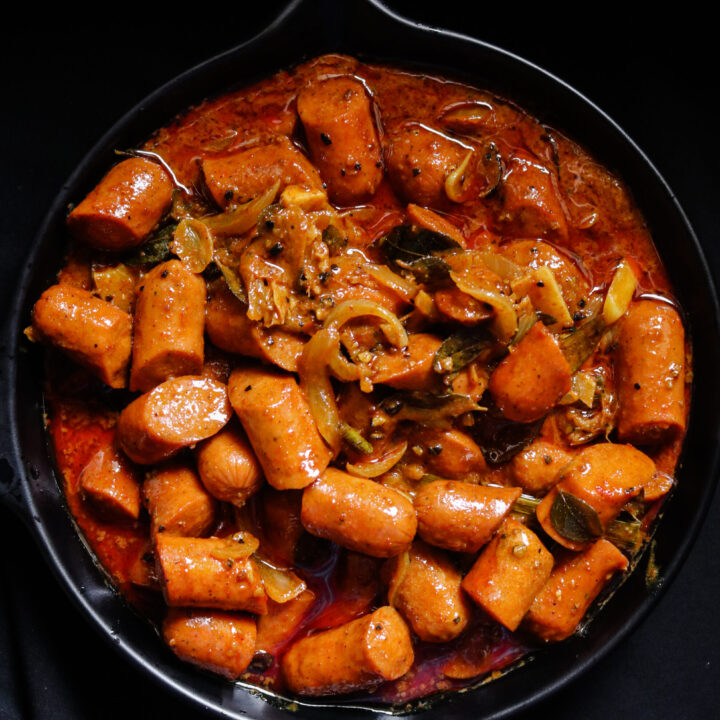 sausage curry served in a bowl.