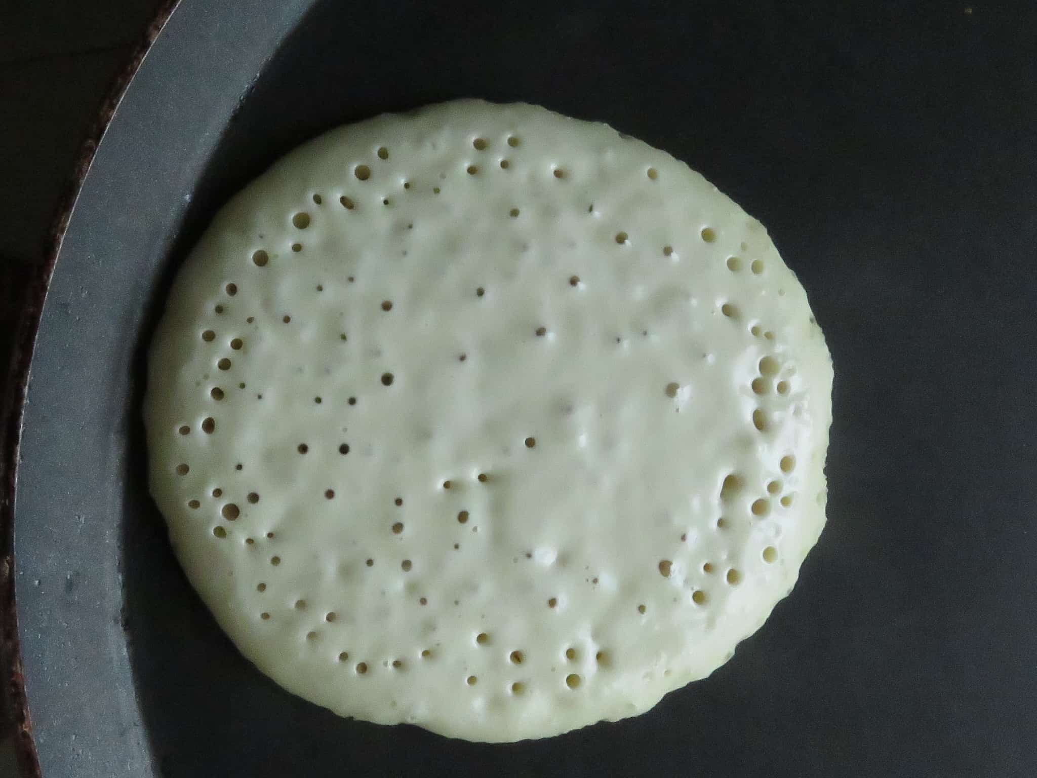 image shows tiny holes appearing on the pancakes as it cooks.