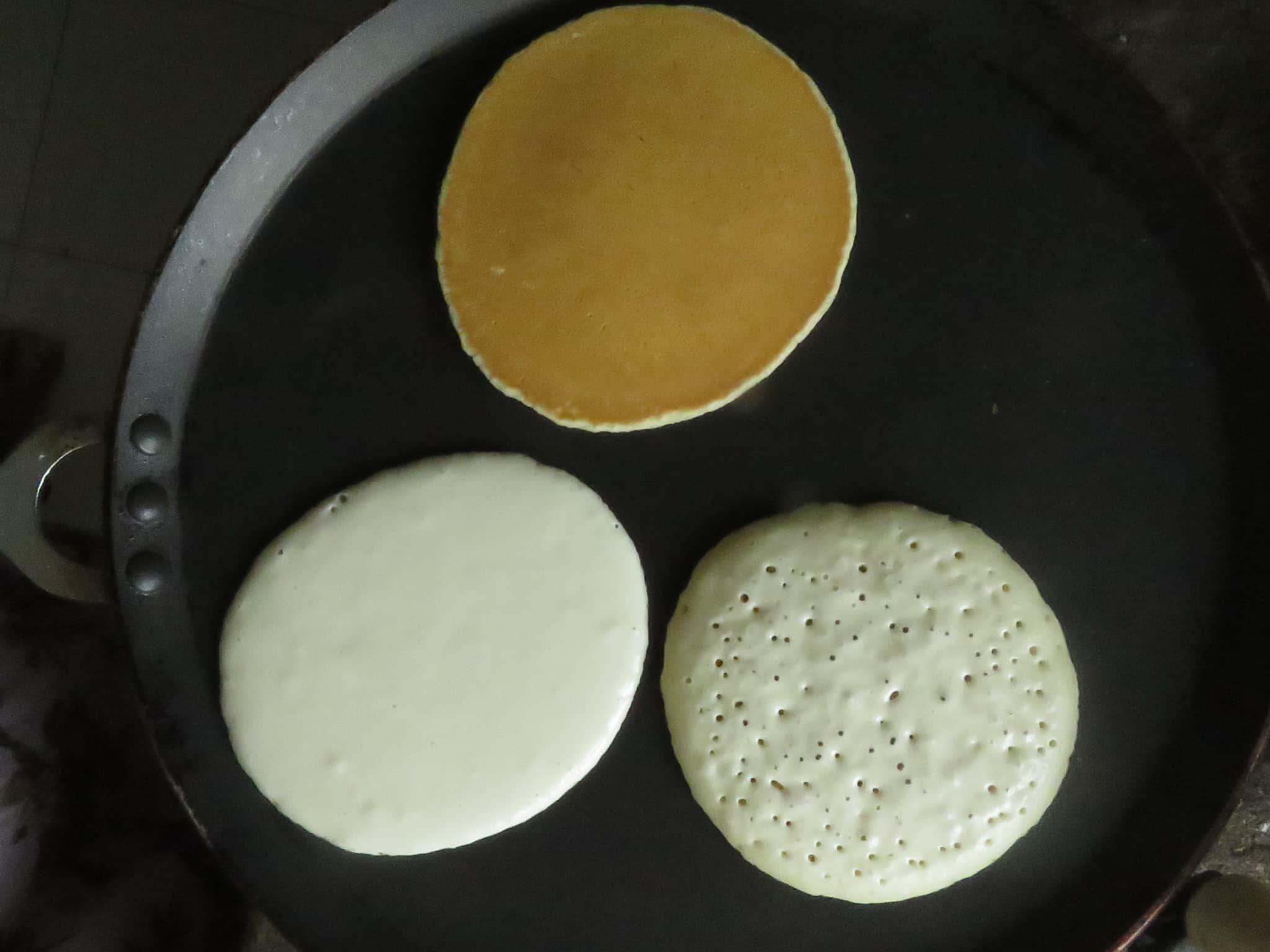 image shows how to cook three pancakes at the same time, the pancakes are in different stages of cooking.