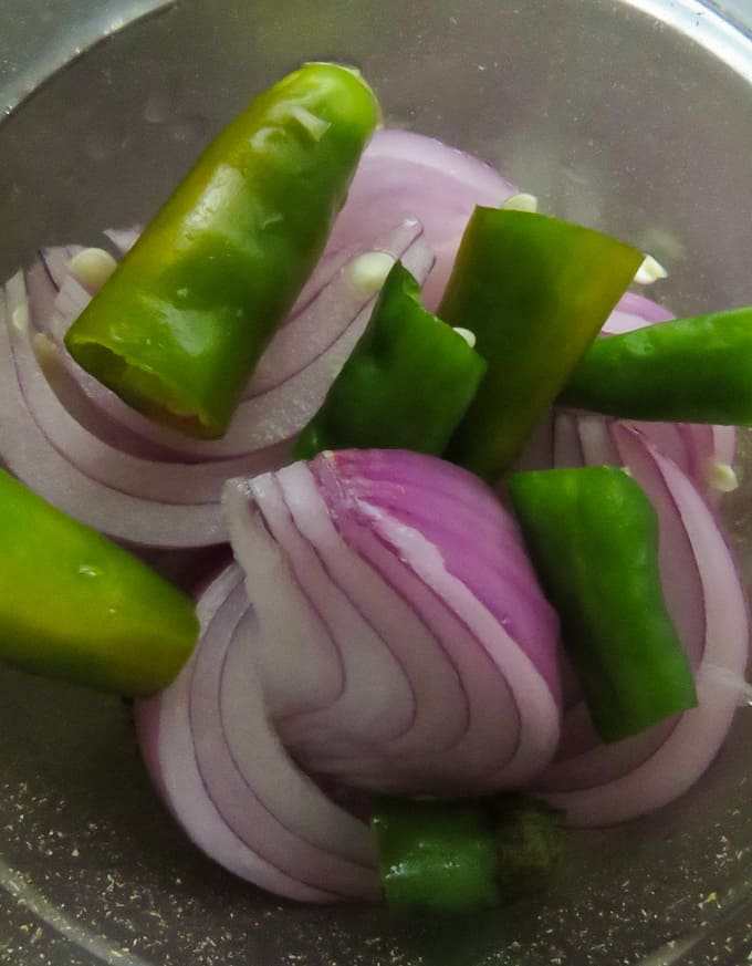 adding onions green chillies to make the rasam paste