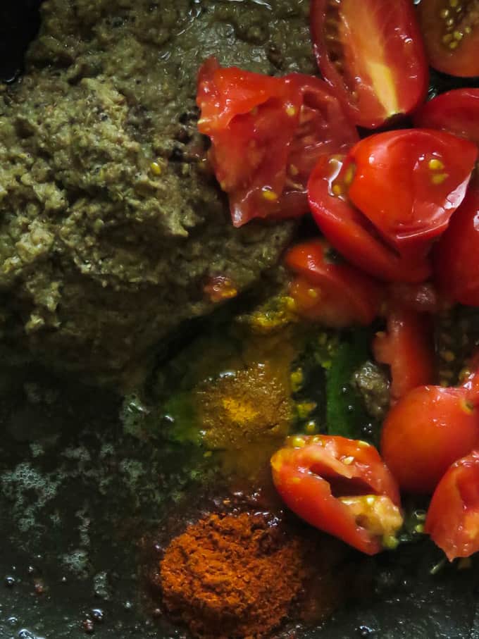 cooking the raw rasam spice paste.