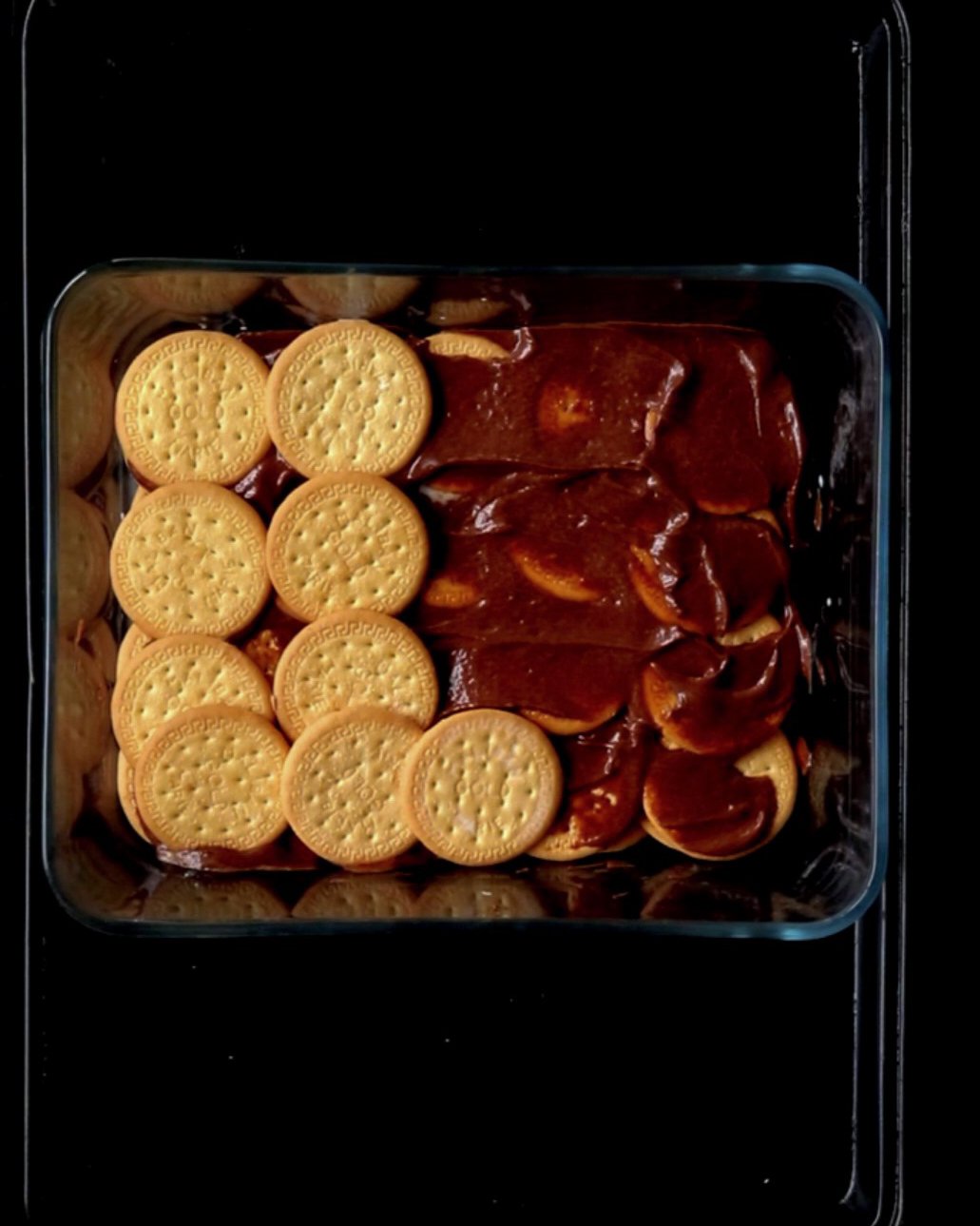 adding third layer of biscuit for the no bake pudding.