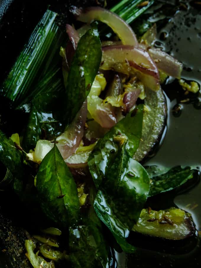 tempering pandan, curry leaf, onions in oil for the cashew curry.