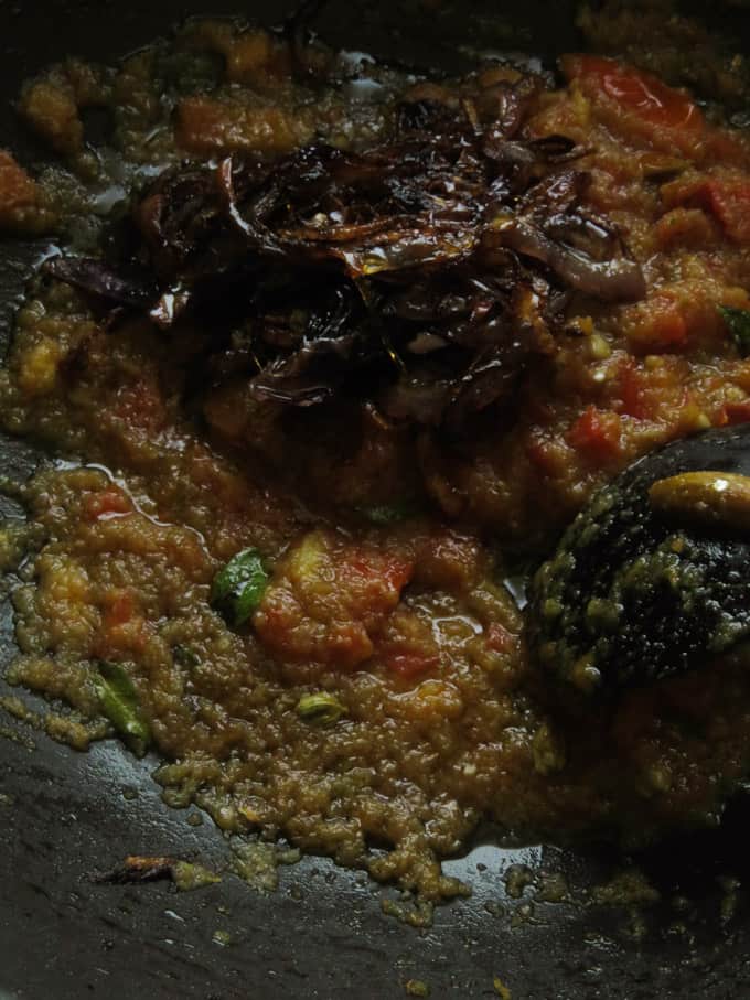 adding the fried onions to the cooked paste.