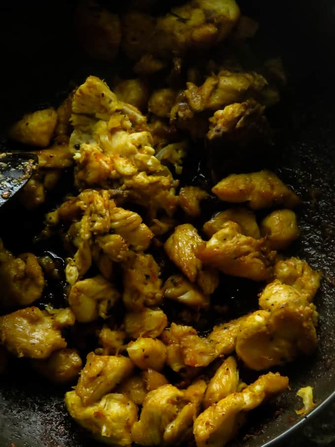 shallow frying the chicken for the dolphin kottu.