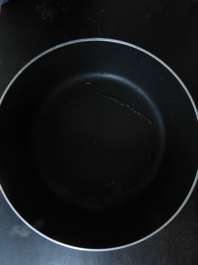 a heavy bottomed pan with a wide mouth shown as an example to make the egg biryani.