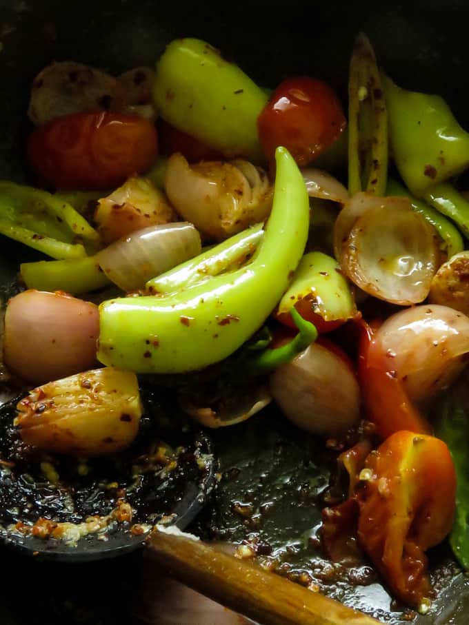 adding ginger,soy to the stir-frying ingredients to make deviled fish.