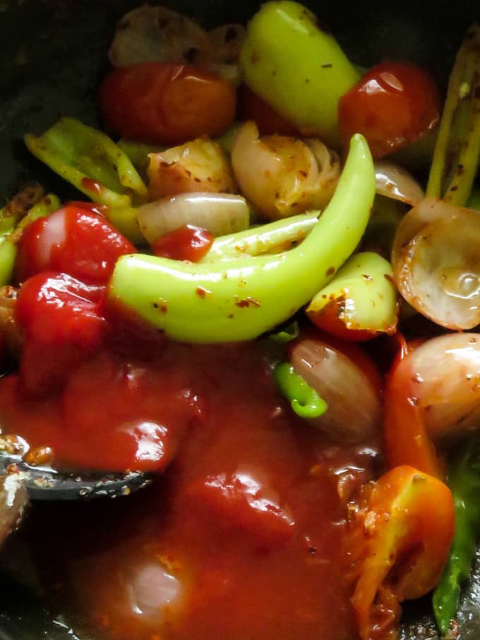 adding ketchup to make the deviled fish sauce.