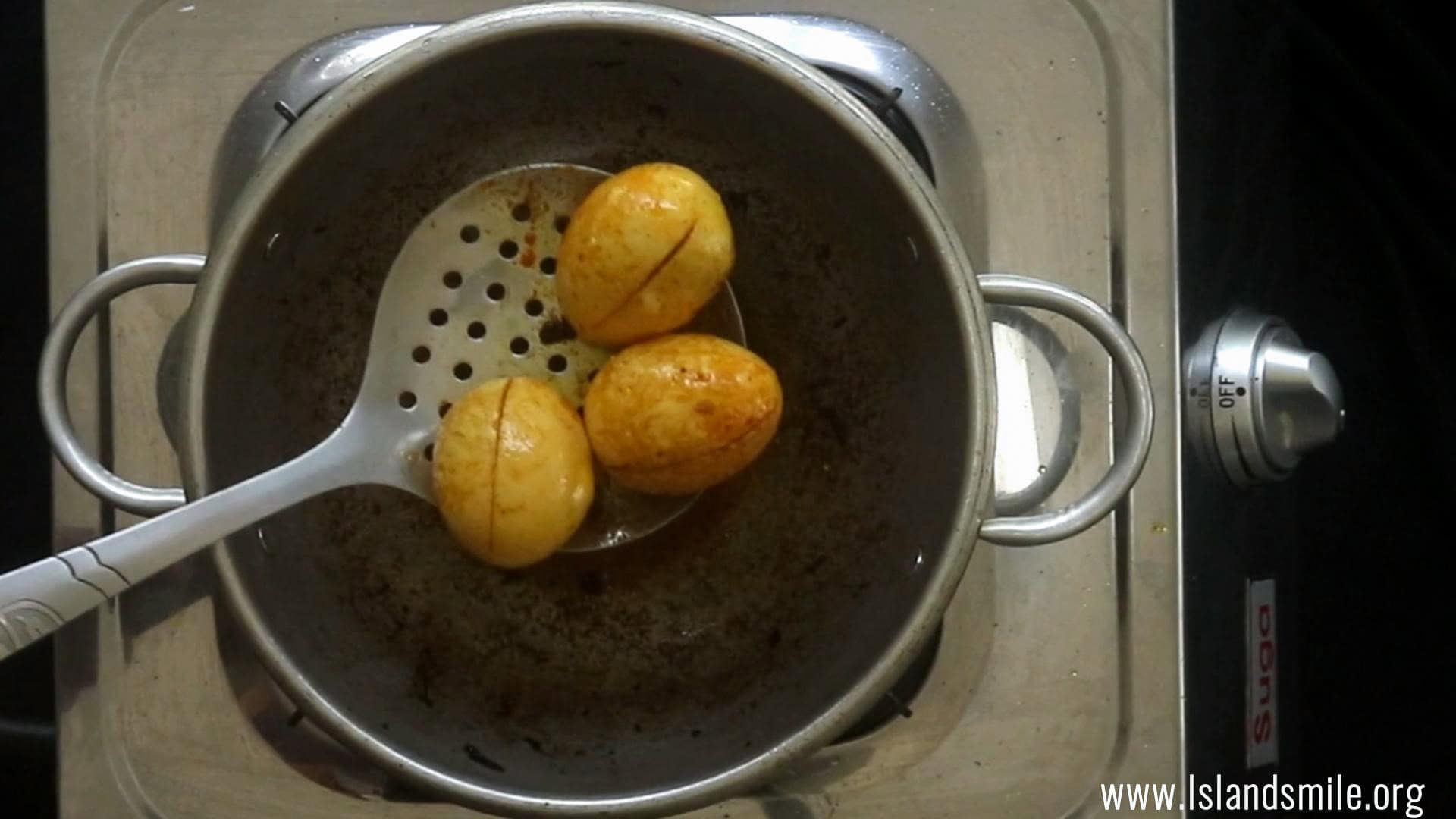 frying the eggs to garnish the egg biryani.