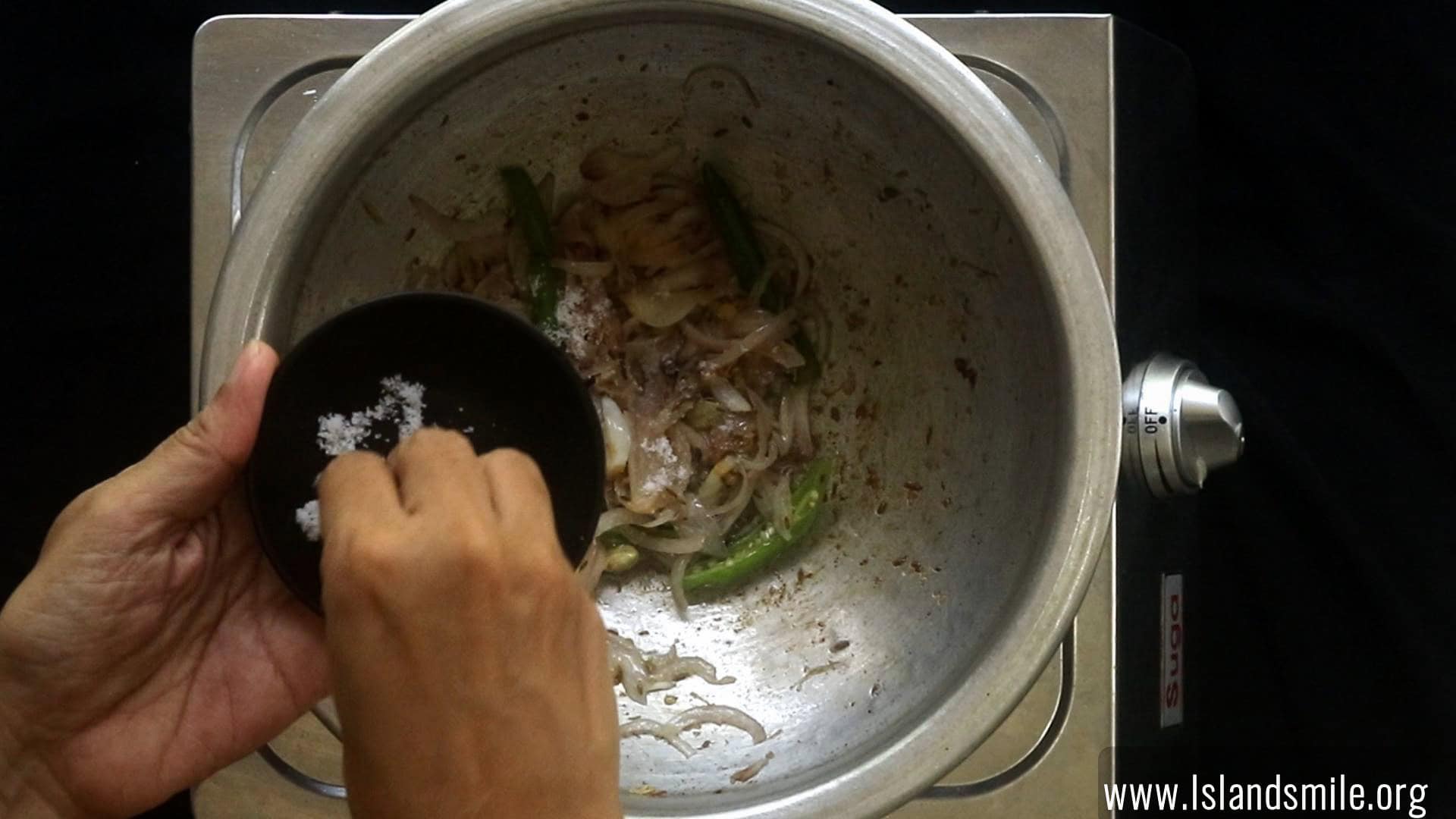 seasoning the cooking onions, to make the egg biryani.