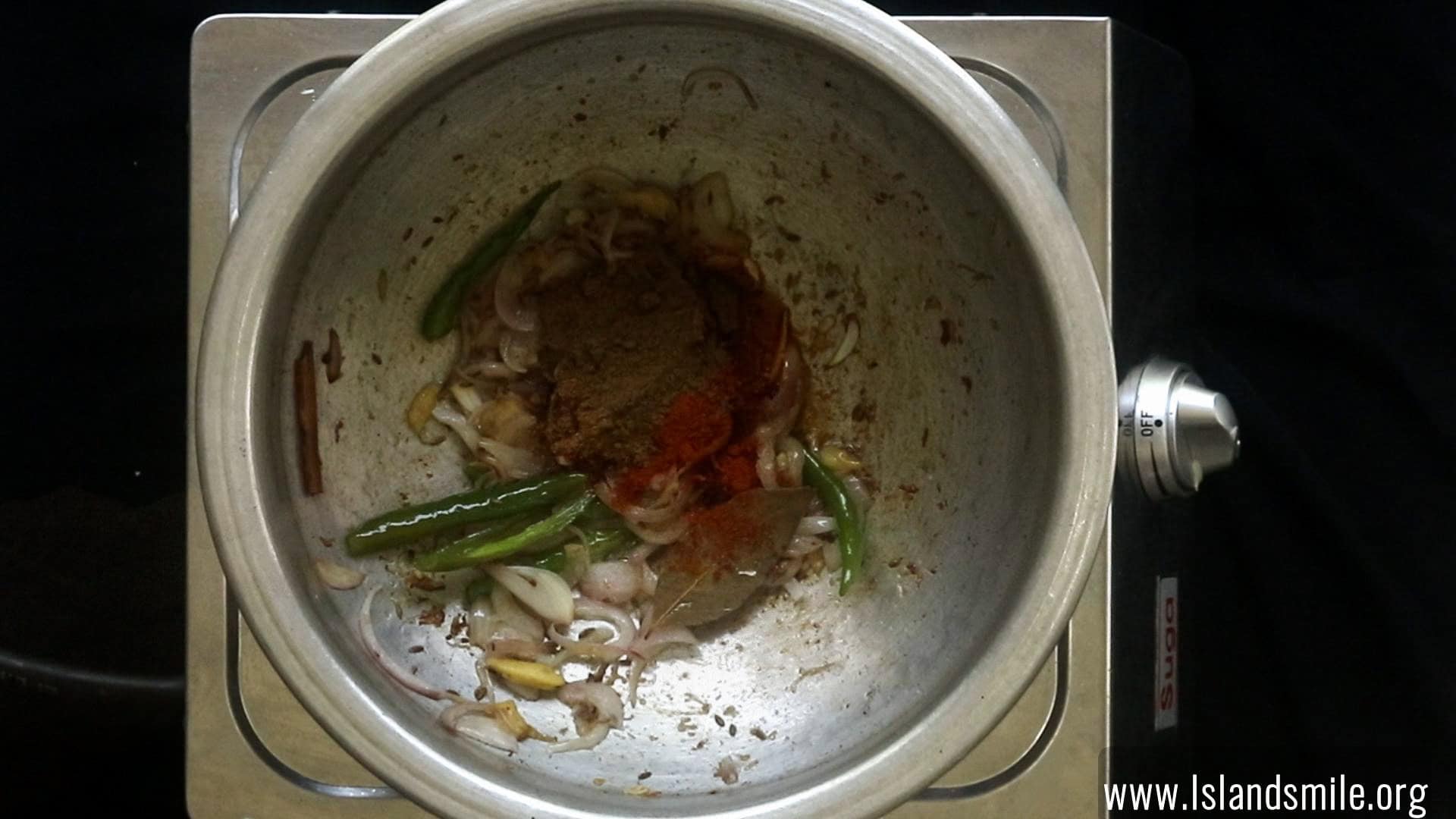 adding curry powders to cook the egg biryani.