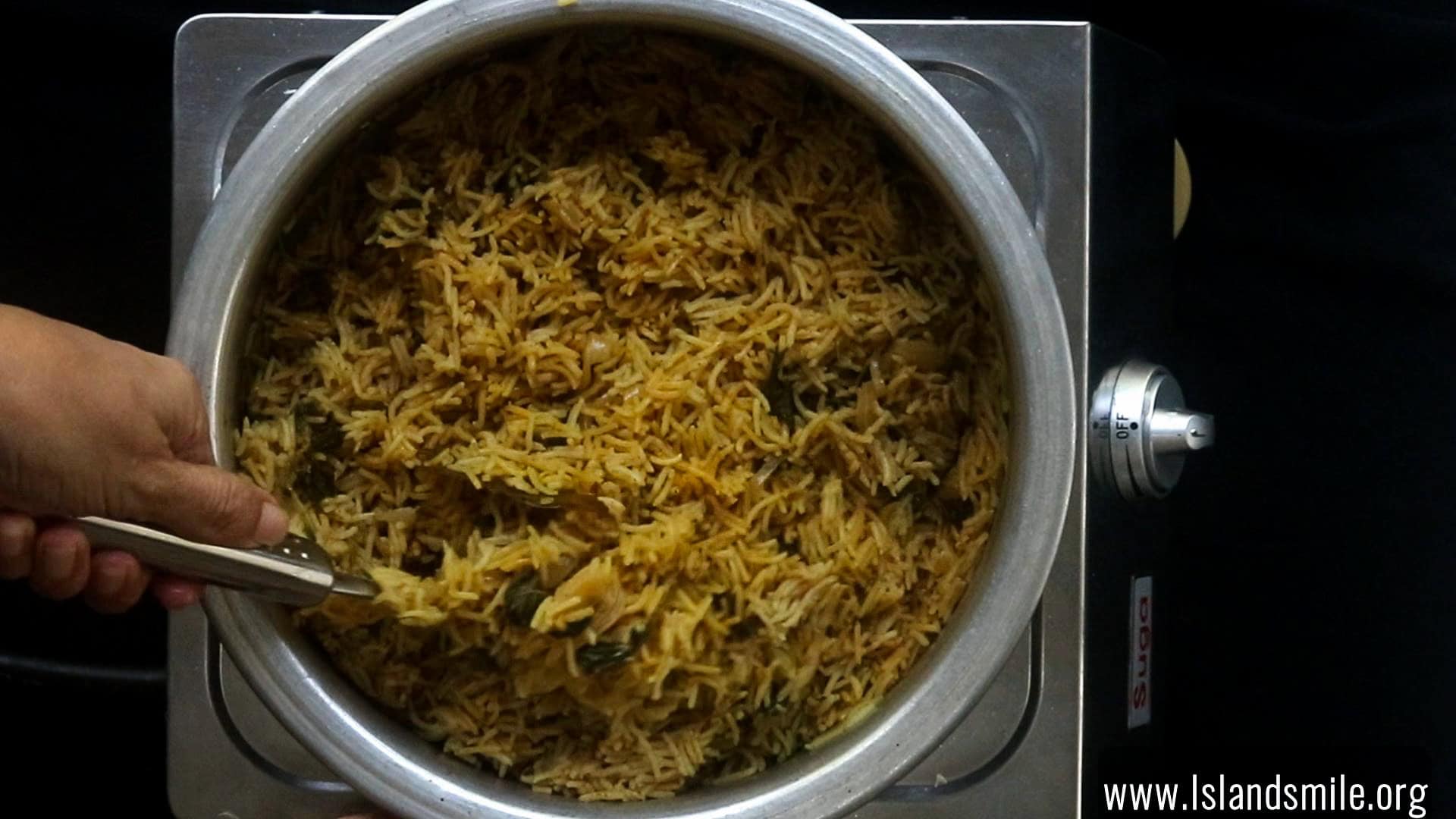 cooked egg biryani with a spoon.