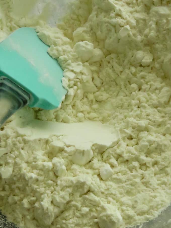 mixing flour, powdered sugar, bakins soda to make the indian cookies.