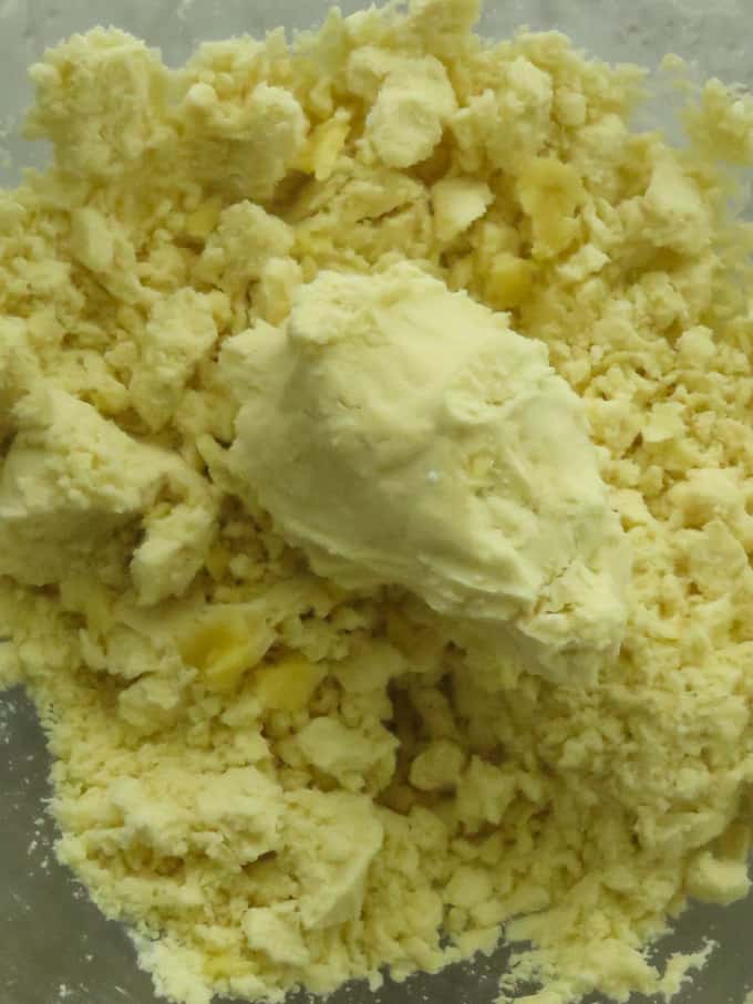 mixing the flour and ghee to reach the correct texture to make the eggless indian cookies.