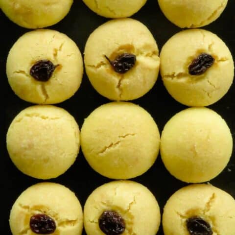 nankhatai(eggless cookies)without raisins and with raisins on a tray.