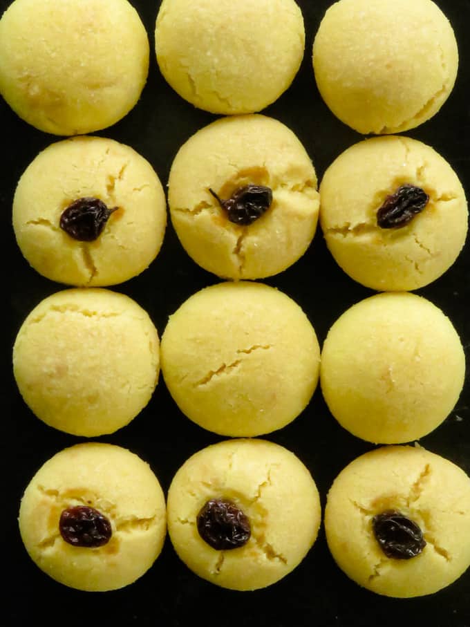 eggless indian ghee cookies on a plate with raisins and without raisins.