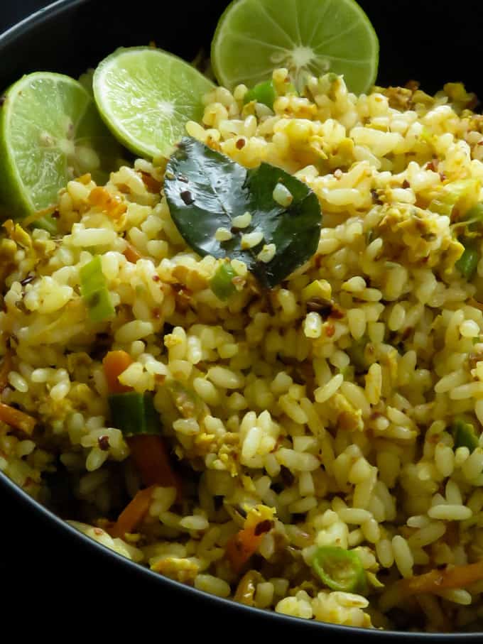 vegetabble fried rice in a bowl with some line wedges.