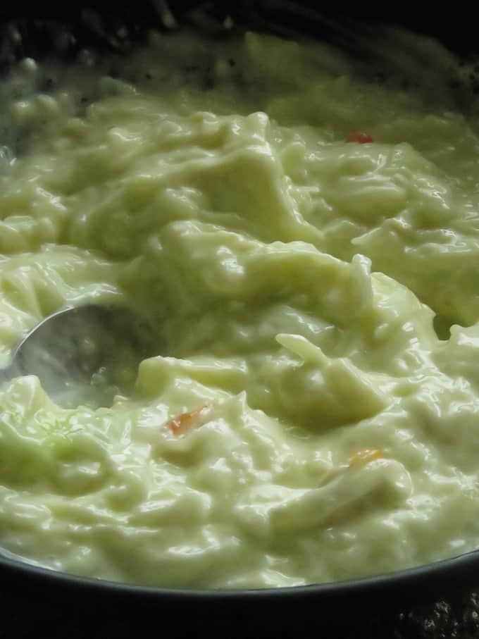 mixing all the ingredients to make the cucumber raita.
