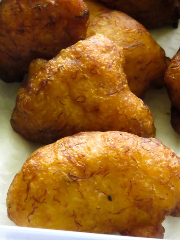 combining flour and the mashed banana to make pisang goreng.