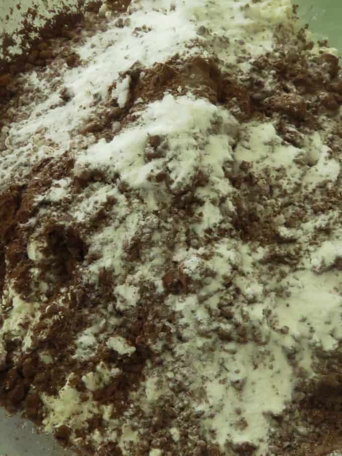 flour, cocoa powder, baking powder and salt combined in a bowl to make the chocolate crinkle cookies.