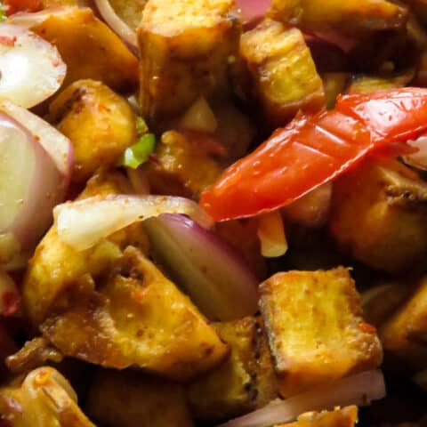 fried ash plantain, mixed with onion, green chillies and spices to make this vegetarian, vegan salad.