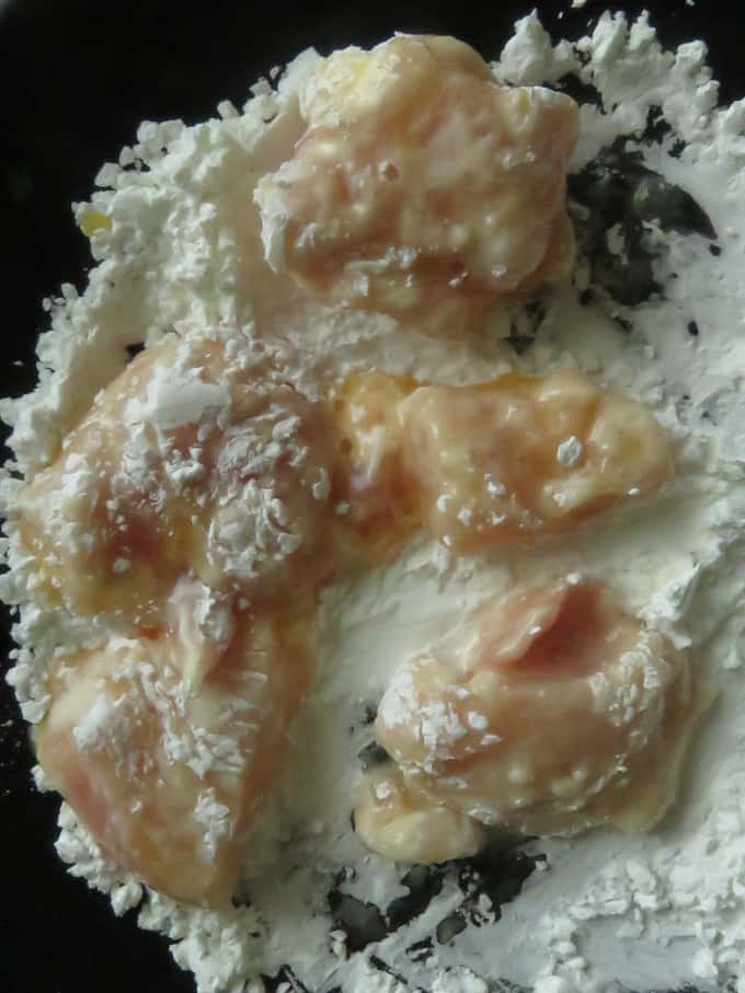 chicken cubes coated with cornflour to make chicken in and sour sauce