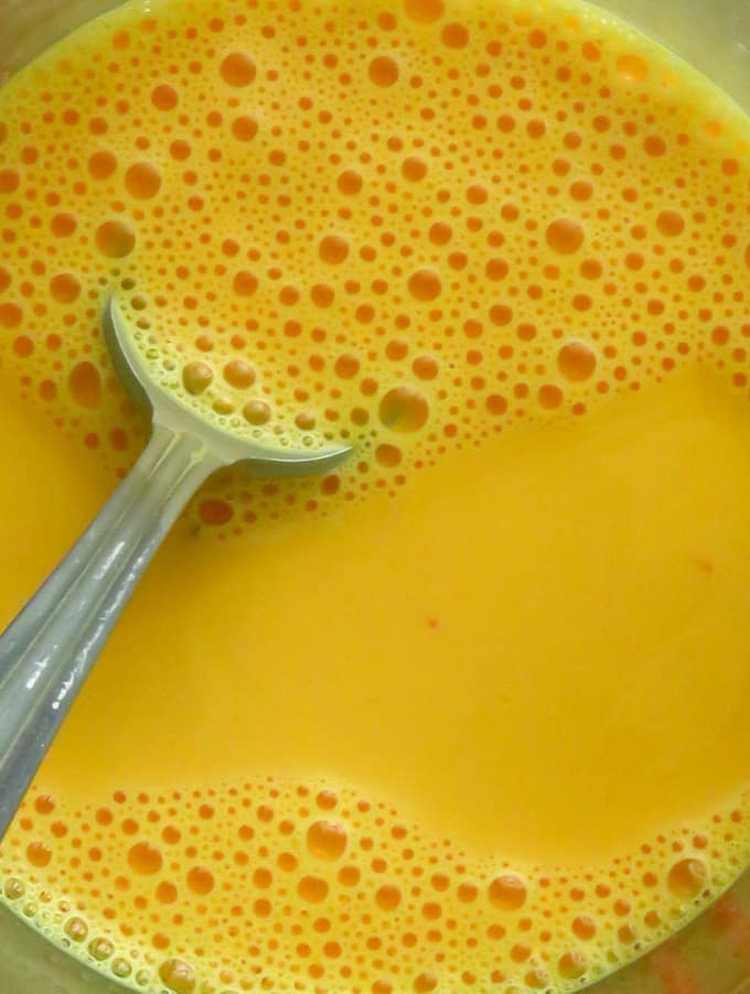 dissolving the custard powder into the milk to make the custard pudding