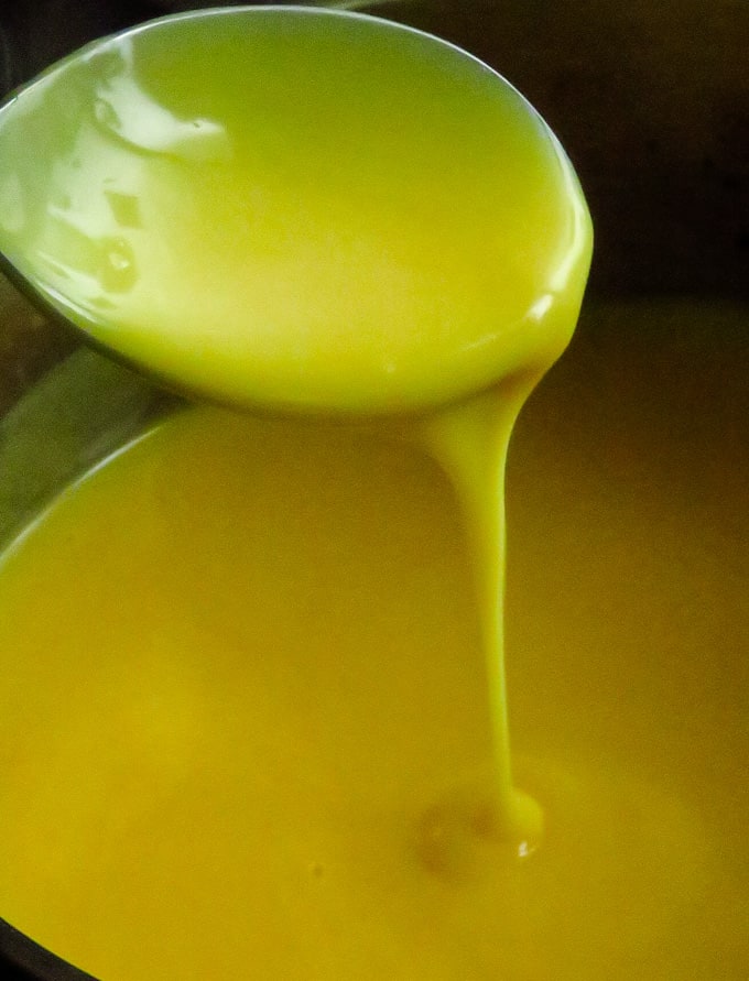 thickening the custard mixture with a spoon