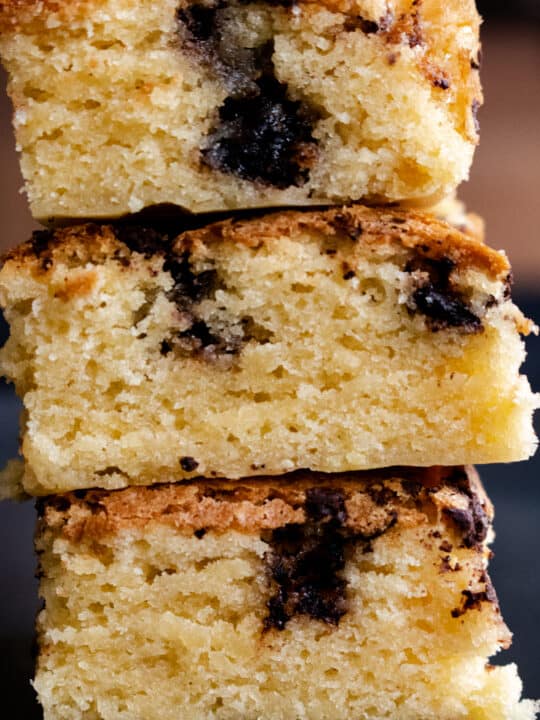 chocolate chunk blondies stacked on top of each other.