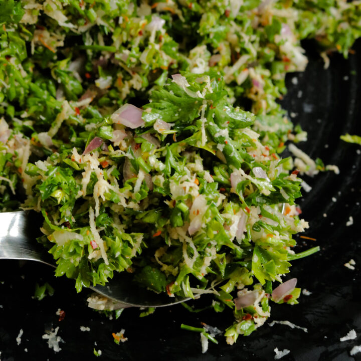 serving parsley salad with a spoon