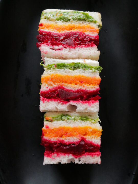 Stack of ribbon or rainbow sandwiches served on a platter