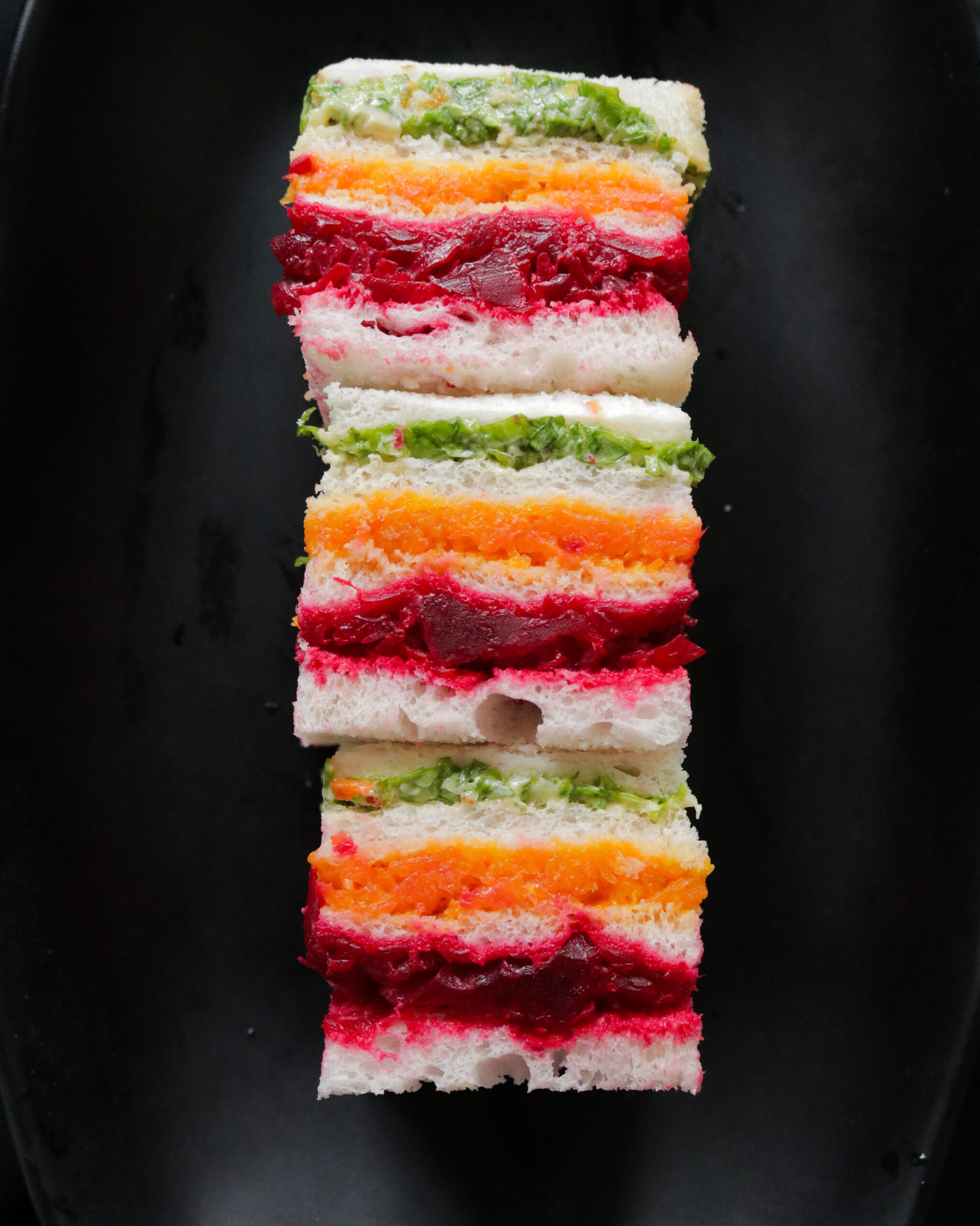 Stack of ribbon or rainbow sandwiches served on a platter