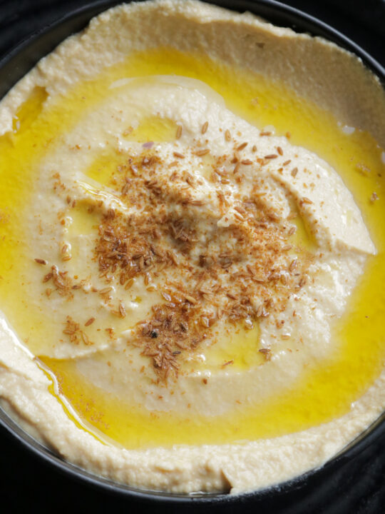 hummus served in a bowl with olive oil