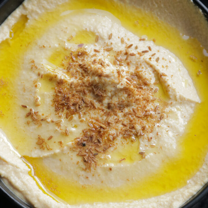 hummus served in a bowl with olive oil