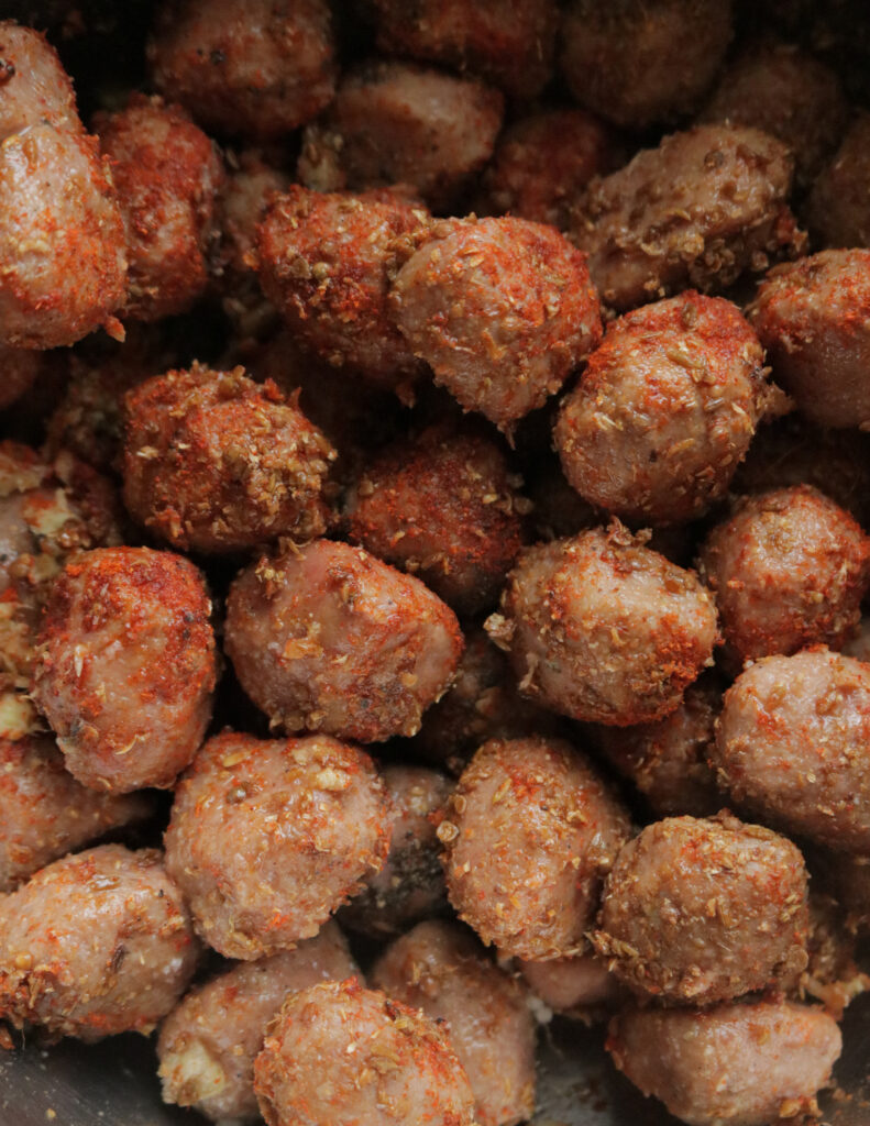 mixing the meatball in spices so they can marinated.