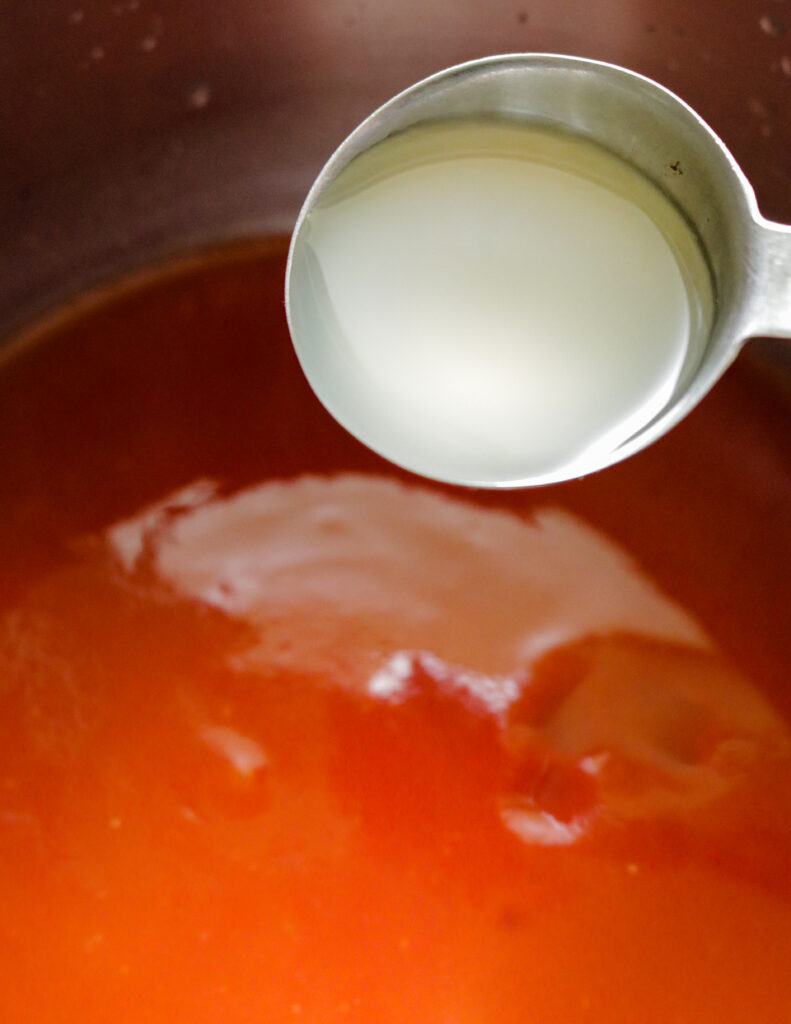 adding vinegar to make the spicy bbq sauce