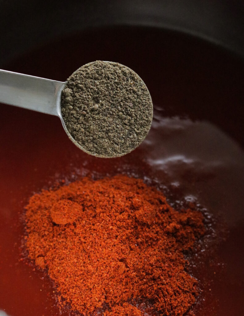 adding pepper to make the spicy barbeque sauce