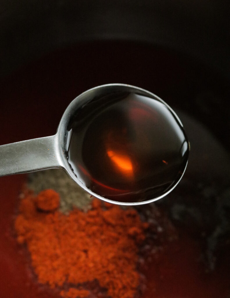 adding honey to cook barbecue sauce