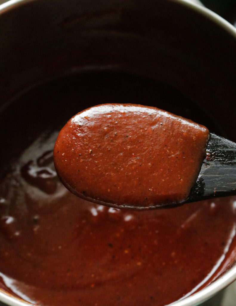 BBQ sauce scooped to a spooon.