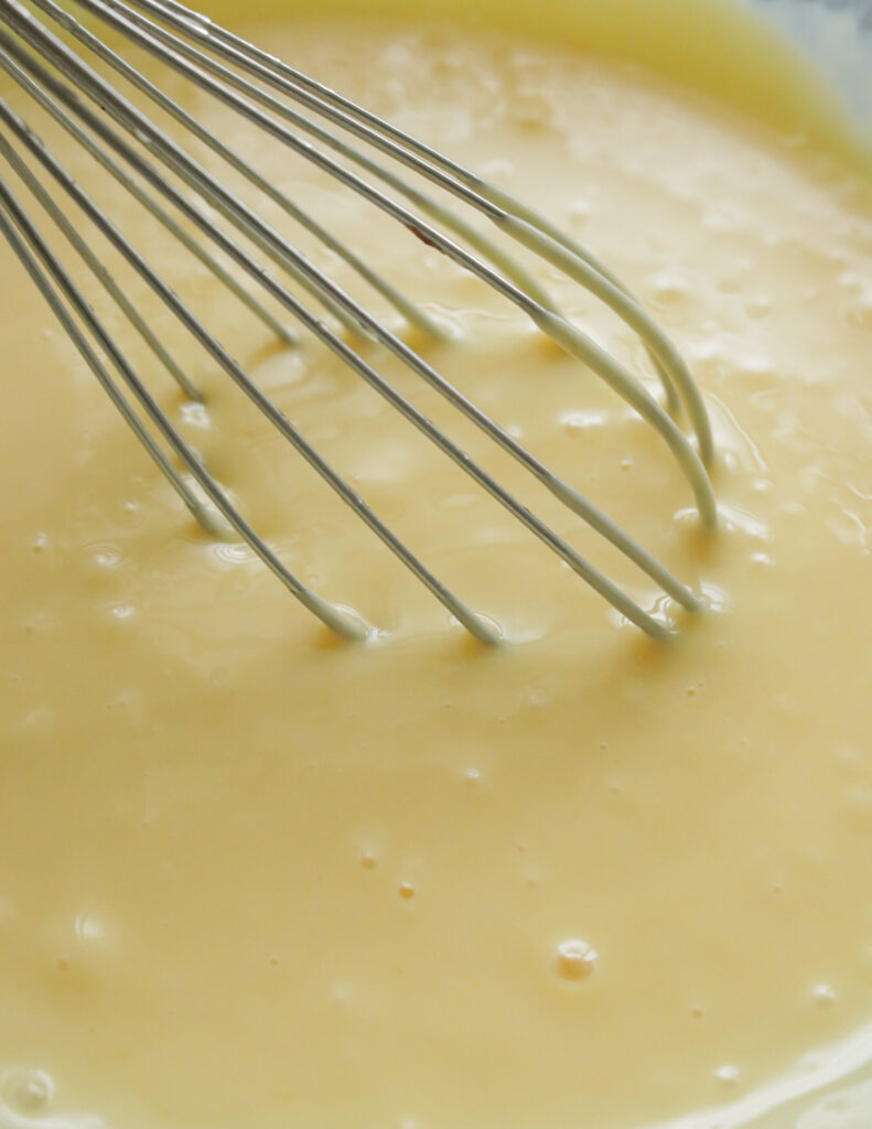 whisking gently to make the lemon filling for the lemon bars.