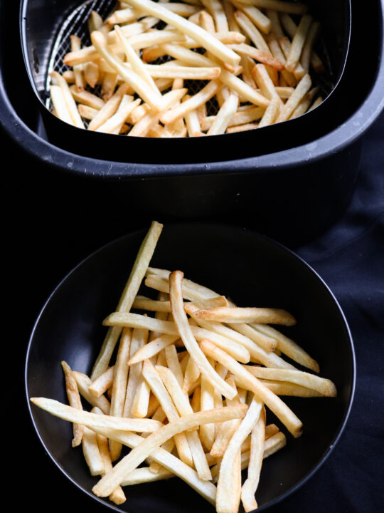 air fried crispy potato fries in a bowl and air fryer