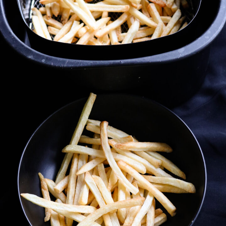 air fried crispy potato fries in a bowl and air fryer