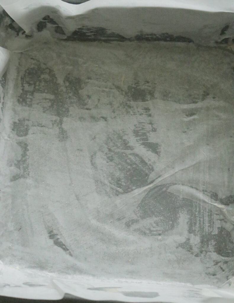 baking tray covered in parchment paper to make the ribbon cake