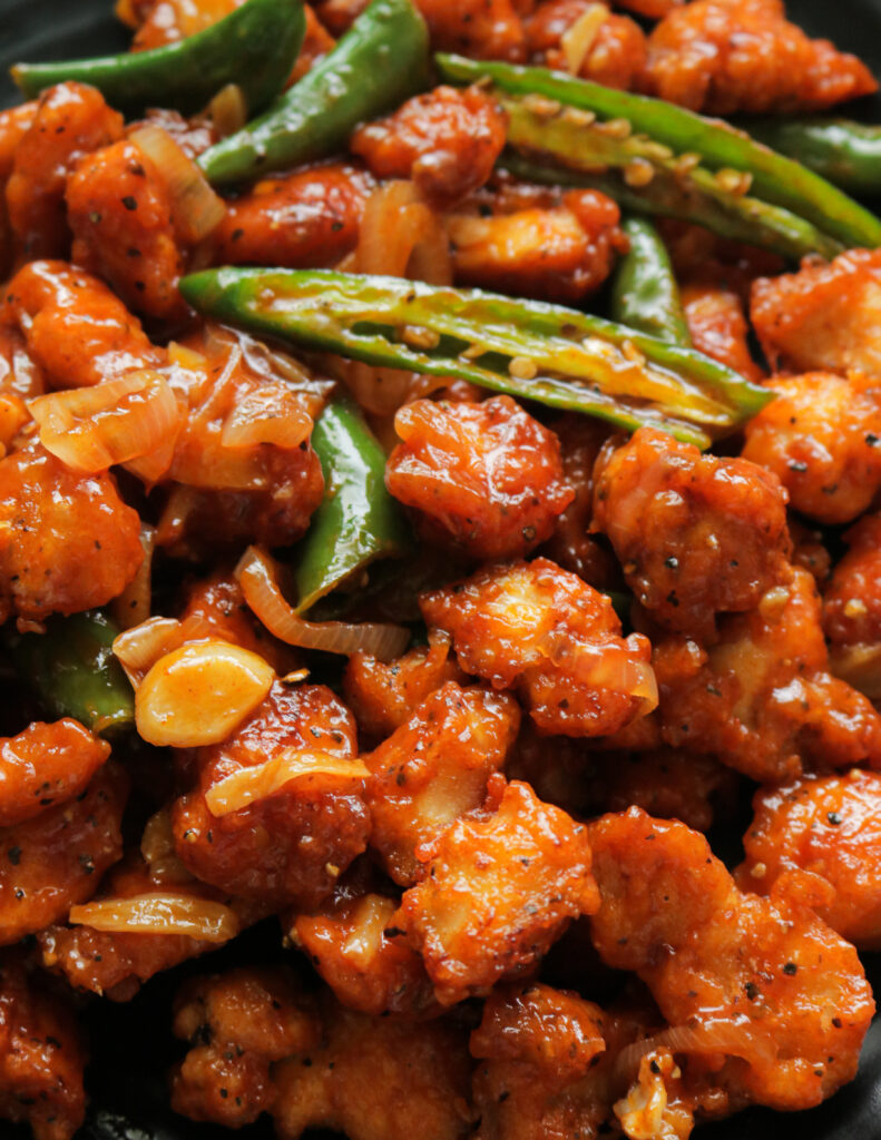 a bowl of Indo chinese chilli chicken. 
