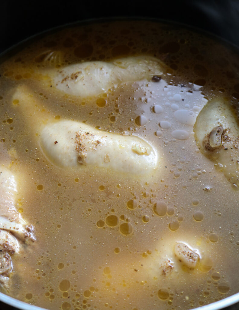 cooked chicken in chicken broth for mandi rice.